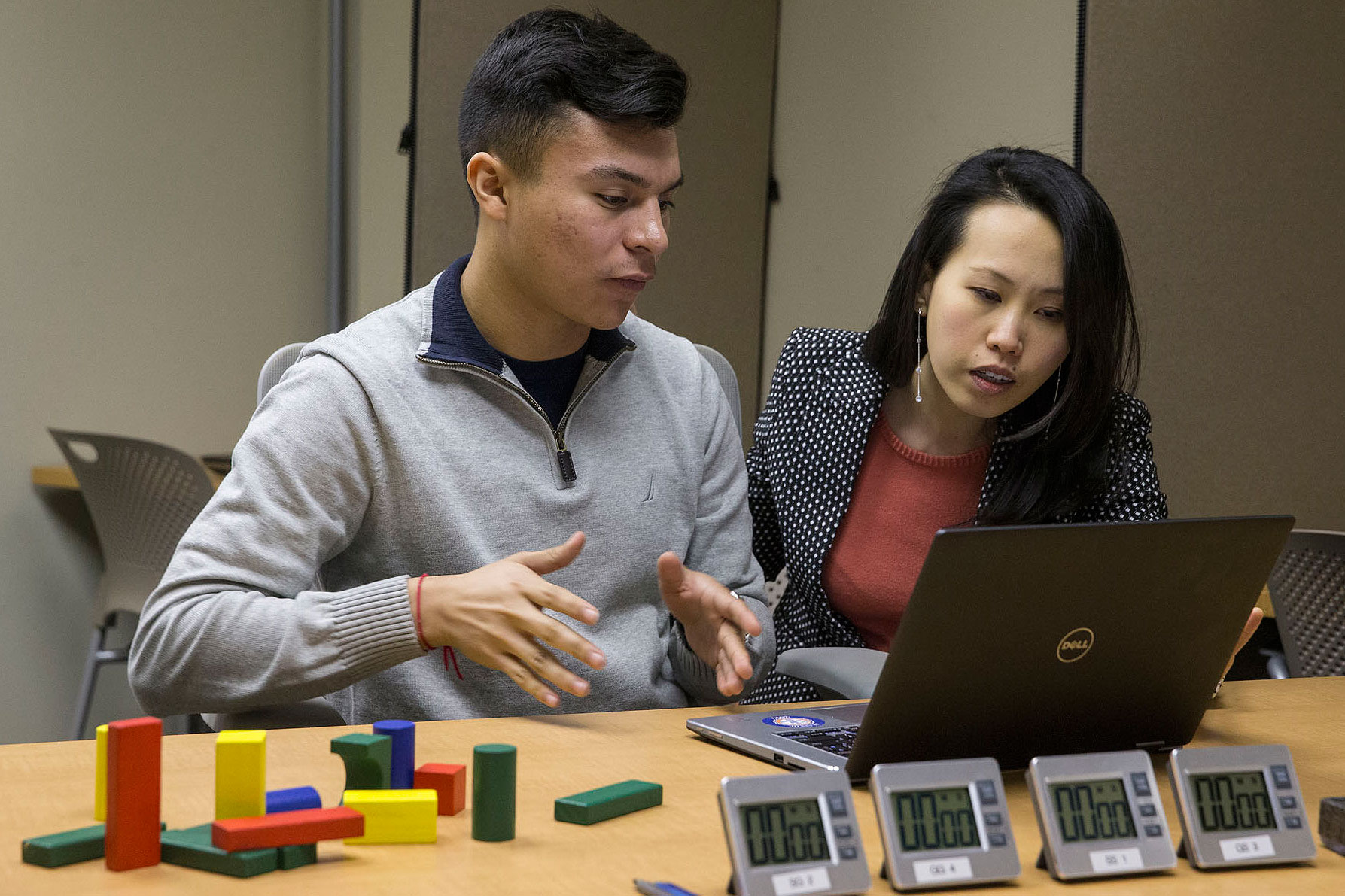 Hector Quijano and Eileen Chou, work on a computer together