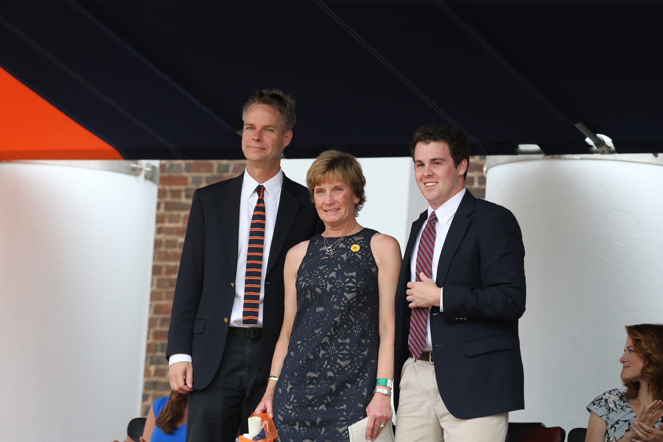  Daniel Judge, right, Margaret Lowe, center, and another man, left, smile for a picture on stage