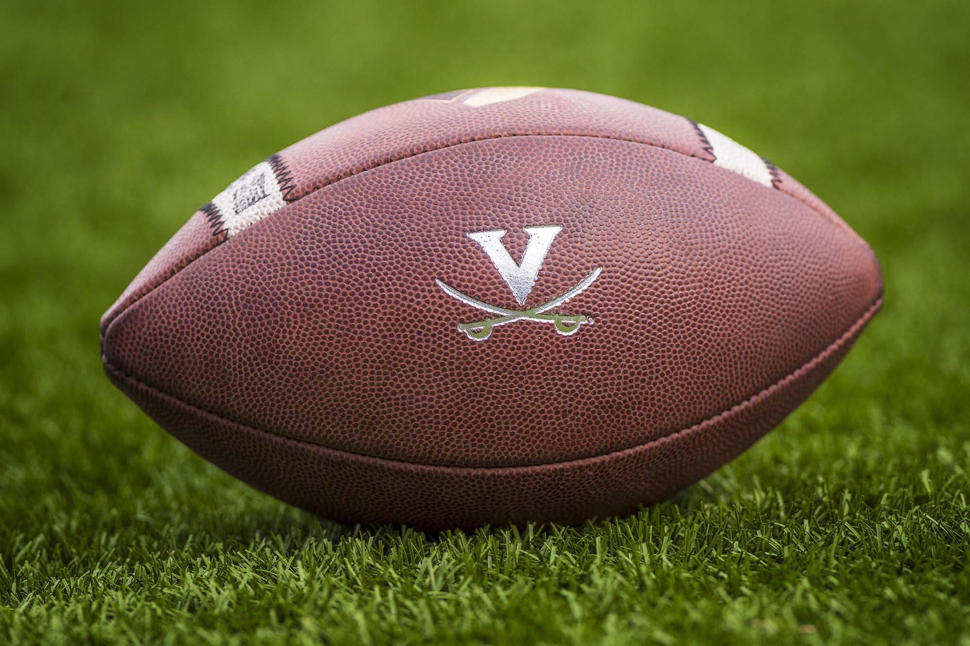 Football with UVA logo on grass