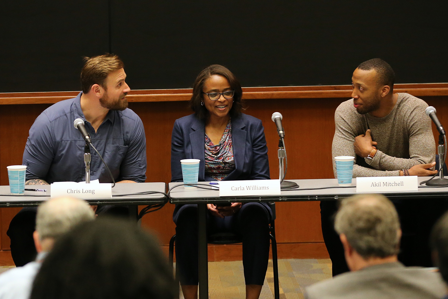 Chris Long,  Carla Williams and Akil Mitchell talk during a panel discussion