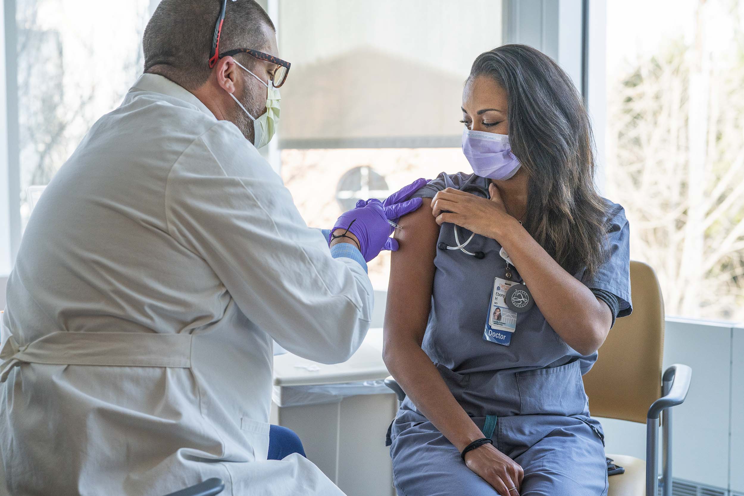 Dr. Ebony Hilton receiving a  vaccine by Justin Vesser