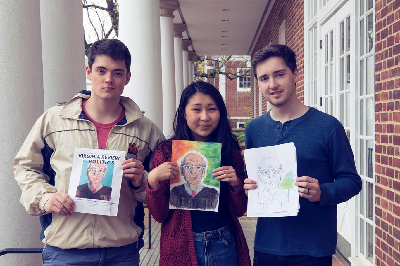 From left, Ethan Sullivan, Aly Lee and Matthew Nalls hold mockups for the first print cover. 