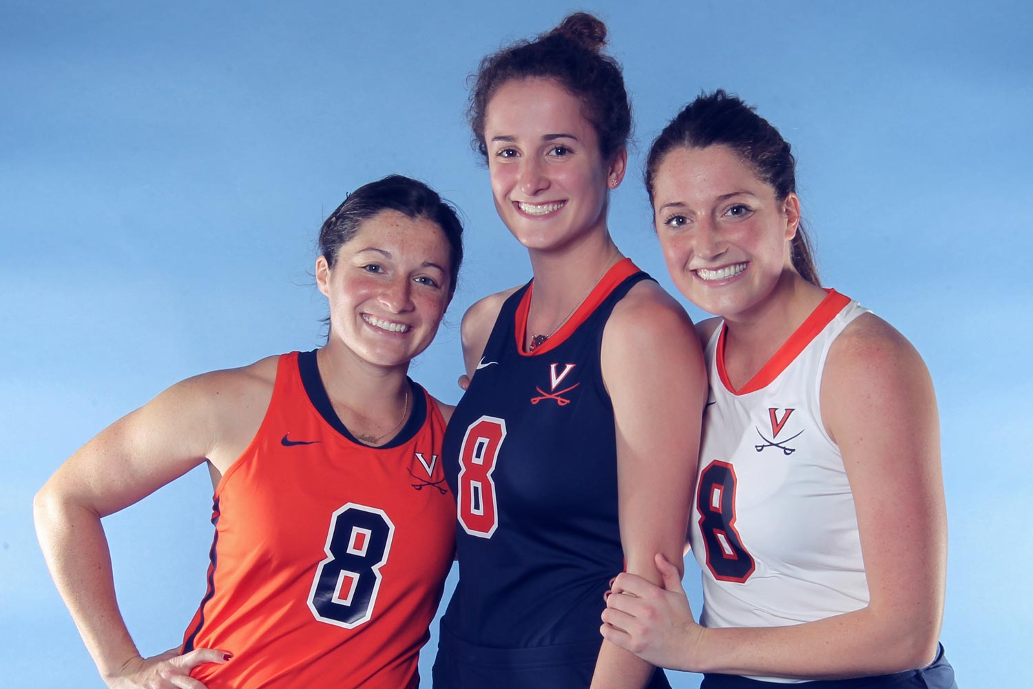 (from left) Michelle, Tara and Carissa Vitesse stand together in UVA uniforms for a picture