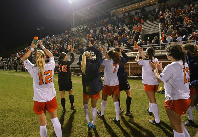 UVA Women's soccer team clapping at the end of a game