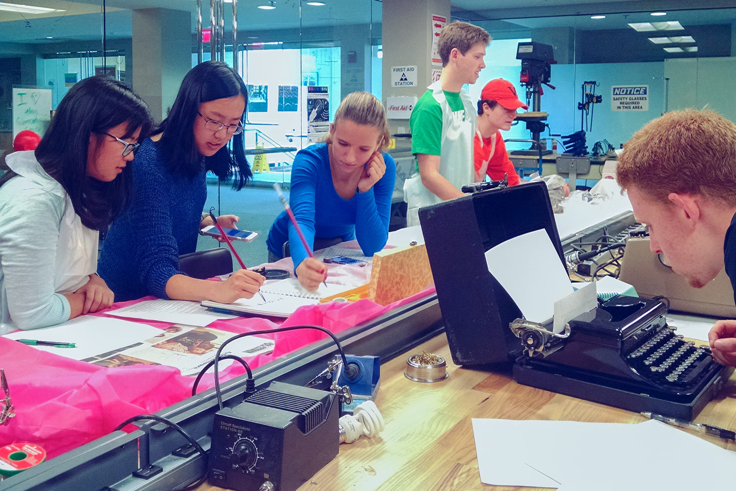 Left to right, Tuyet-Minh Tran, Emily Lin, Ashley Ewing, Paul Qualey and J. Stillman Hanson try out homemade ink and clay tablets, while Myles McPartland checks out a manual typewriter.