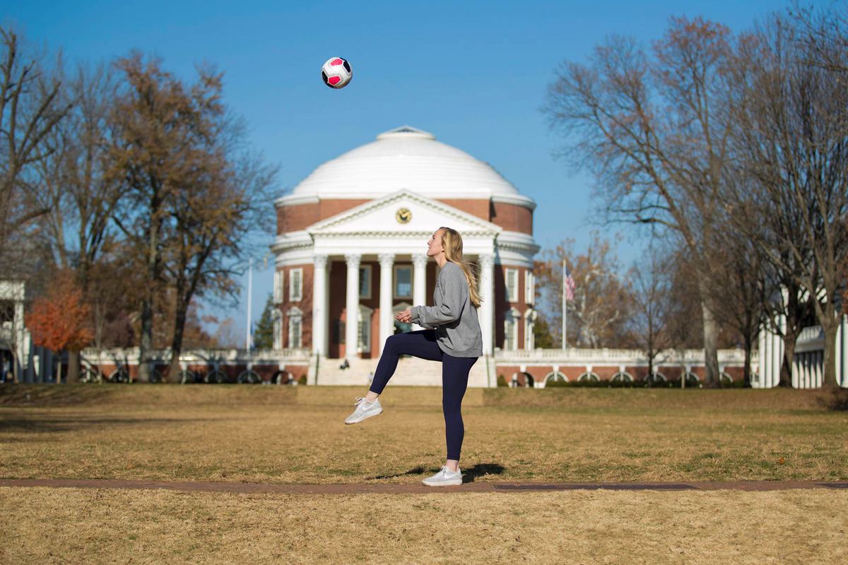 Morse kicking a soccer ball in the air in front of the Rotunda