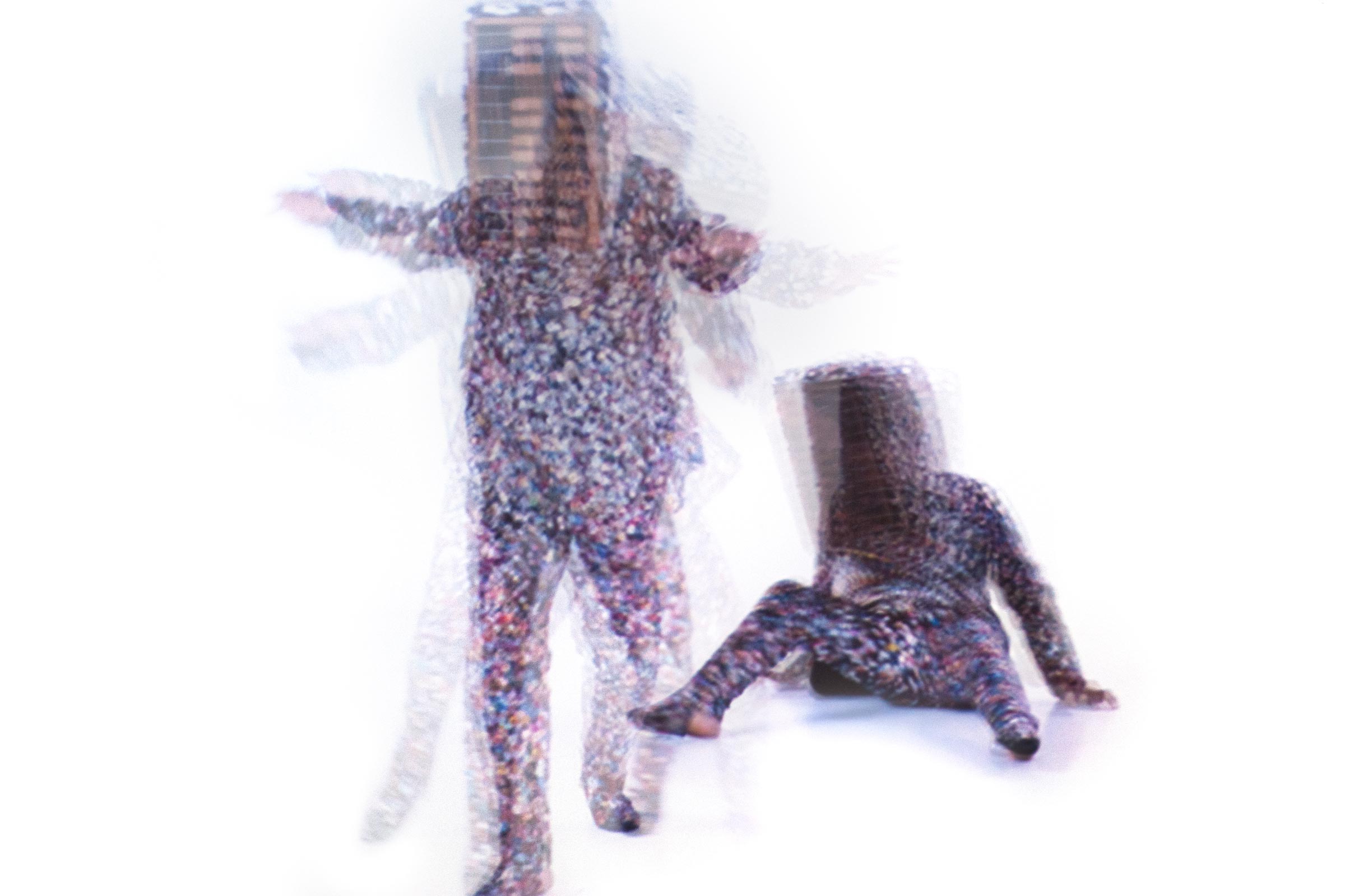 Blurry image of two people moving.  one is standing and one looks like they fell down