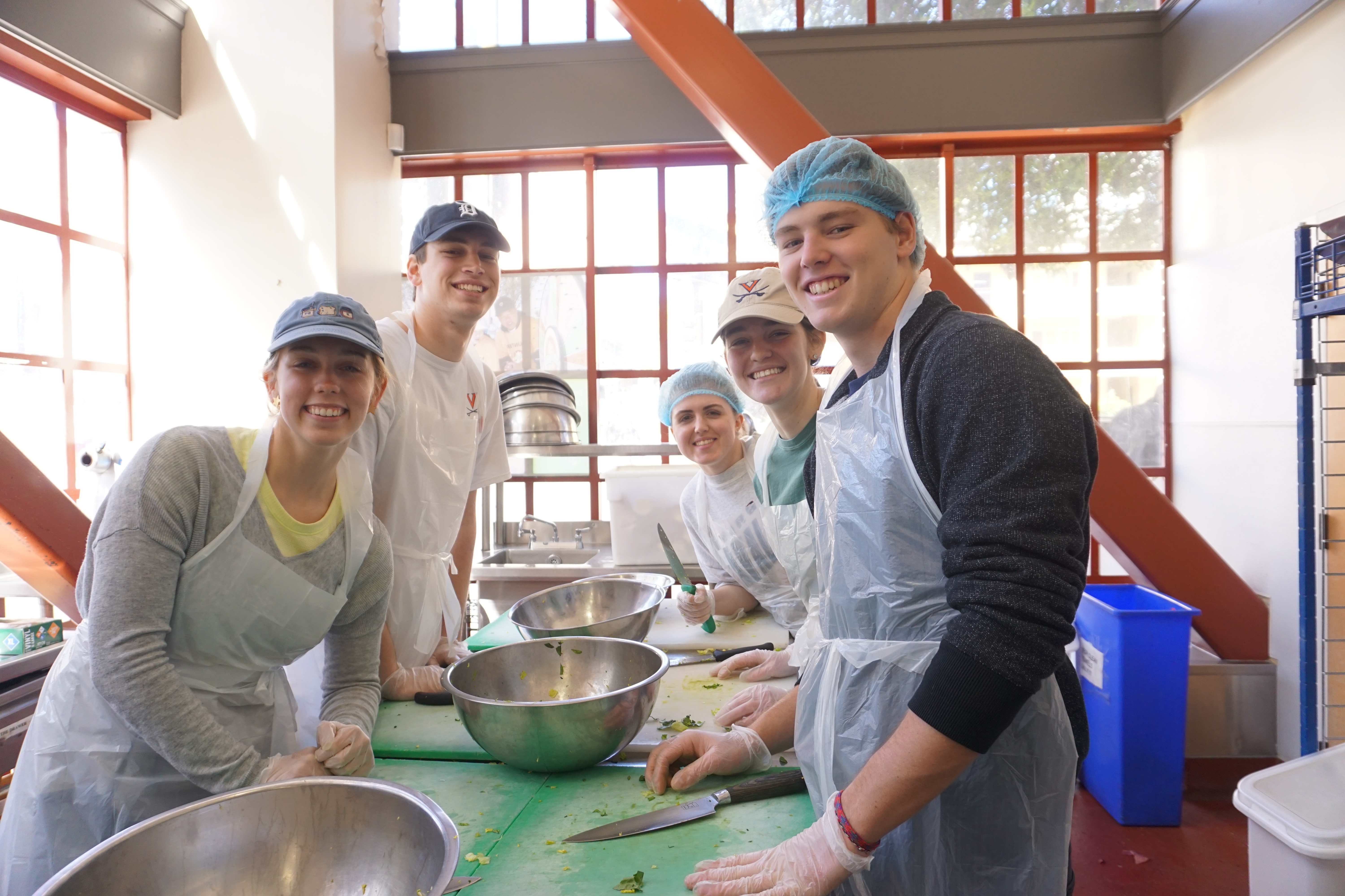 Students smile while preparing a meal