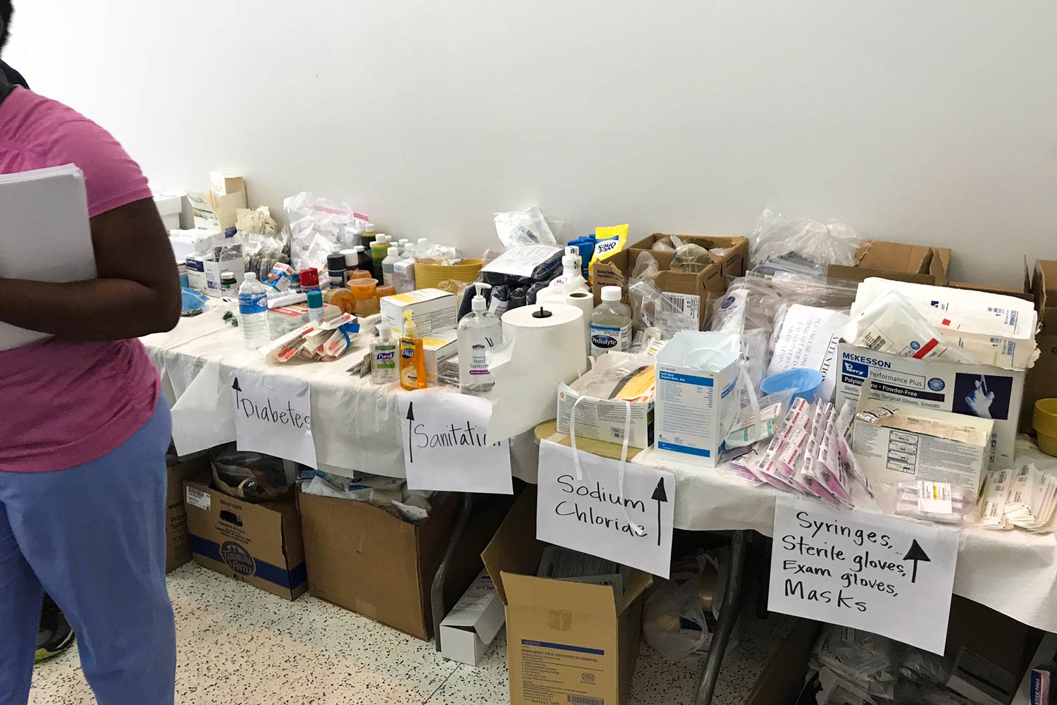 Donations sitting on a table with signs indicating what each section contains