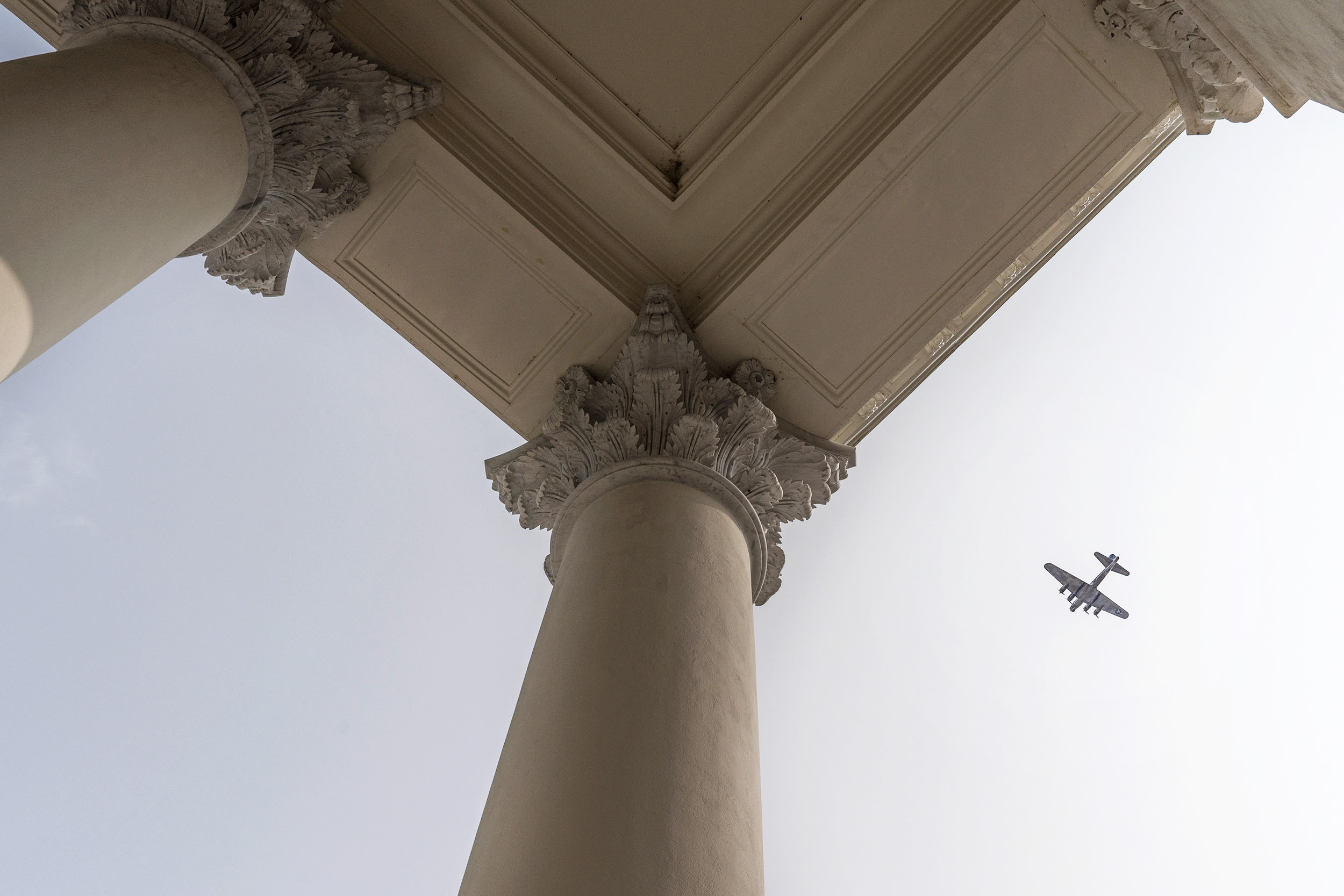 View of the Columns at the Rotunda with a plane flying
