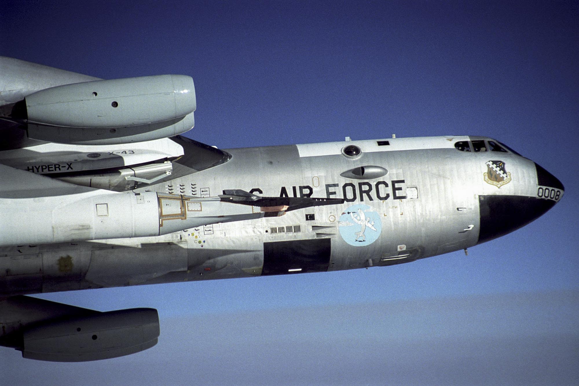 The black X-43A sits on the front of a modified Pegasus booster rocket under the wing of NASA's B-52B mother ship