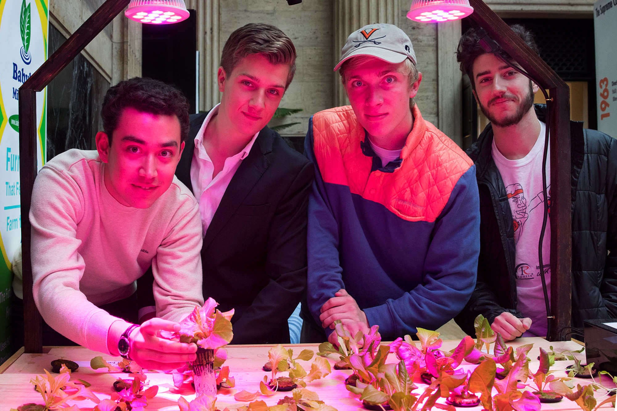 From left, Stefano Rumi, who handles the business expansion of Babylon Micro-Farms; founder Alexander Olesen; electrical engineer Patrick Mahan; and head engineer Graham Smith. (Photo by Dan Addison, University Communications)