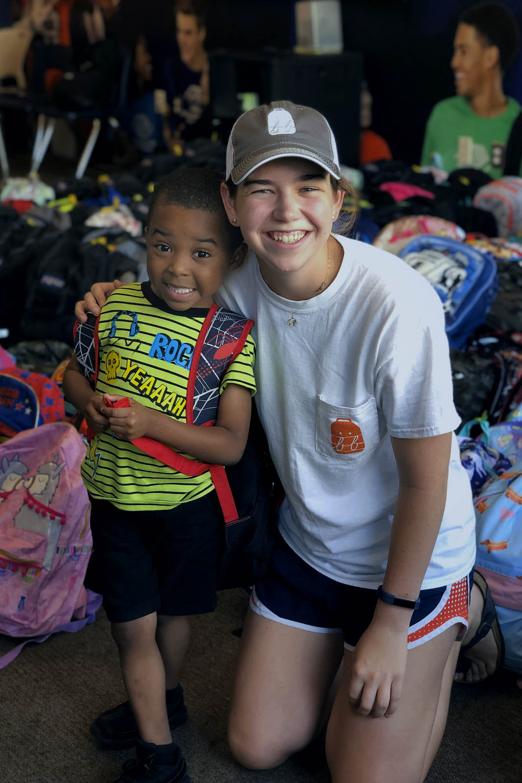 Hoerr, right, placed her arm on the shoulder of a little kid as they pose for a picture