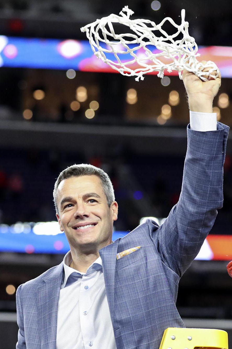 Tony Bennett raising a game winning net above his head