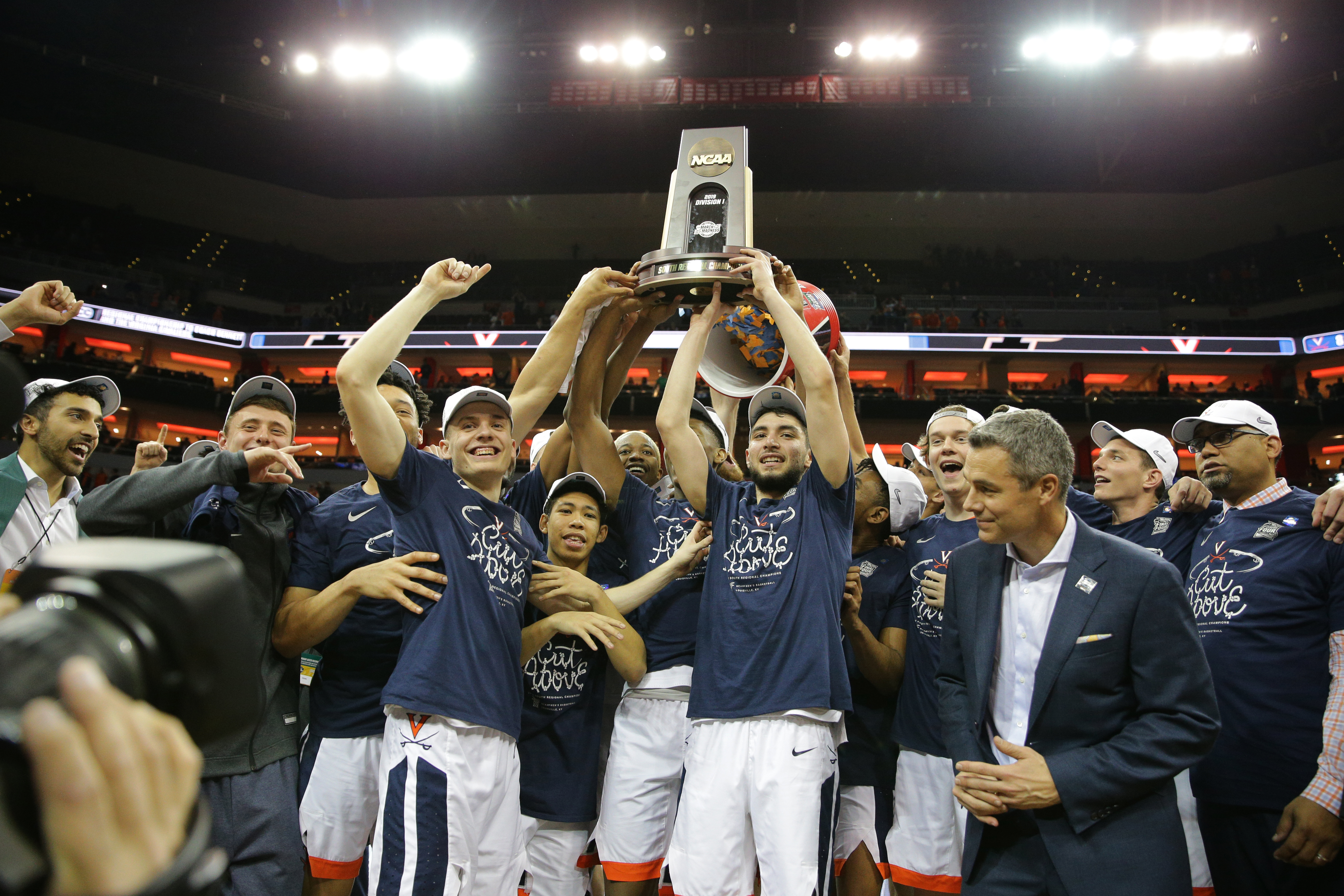 UVA basketball team holds the NCAA trophy above their heads