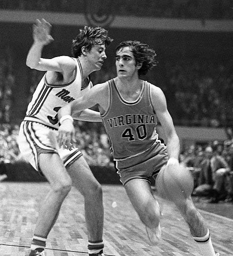 Black and white image of Barry Parkhill dribbling past an opponent