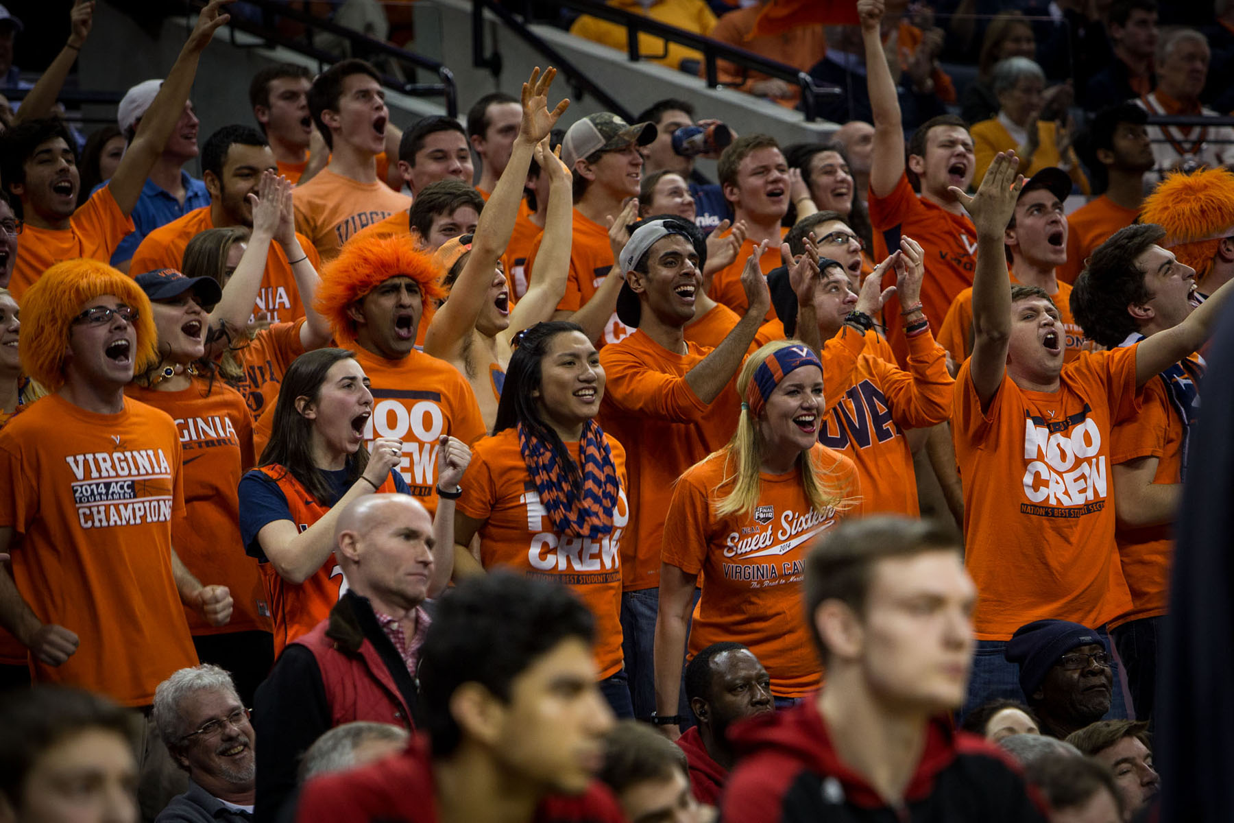 Crowd of UVA students all wearing orange screaming during a basketball game