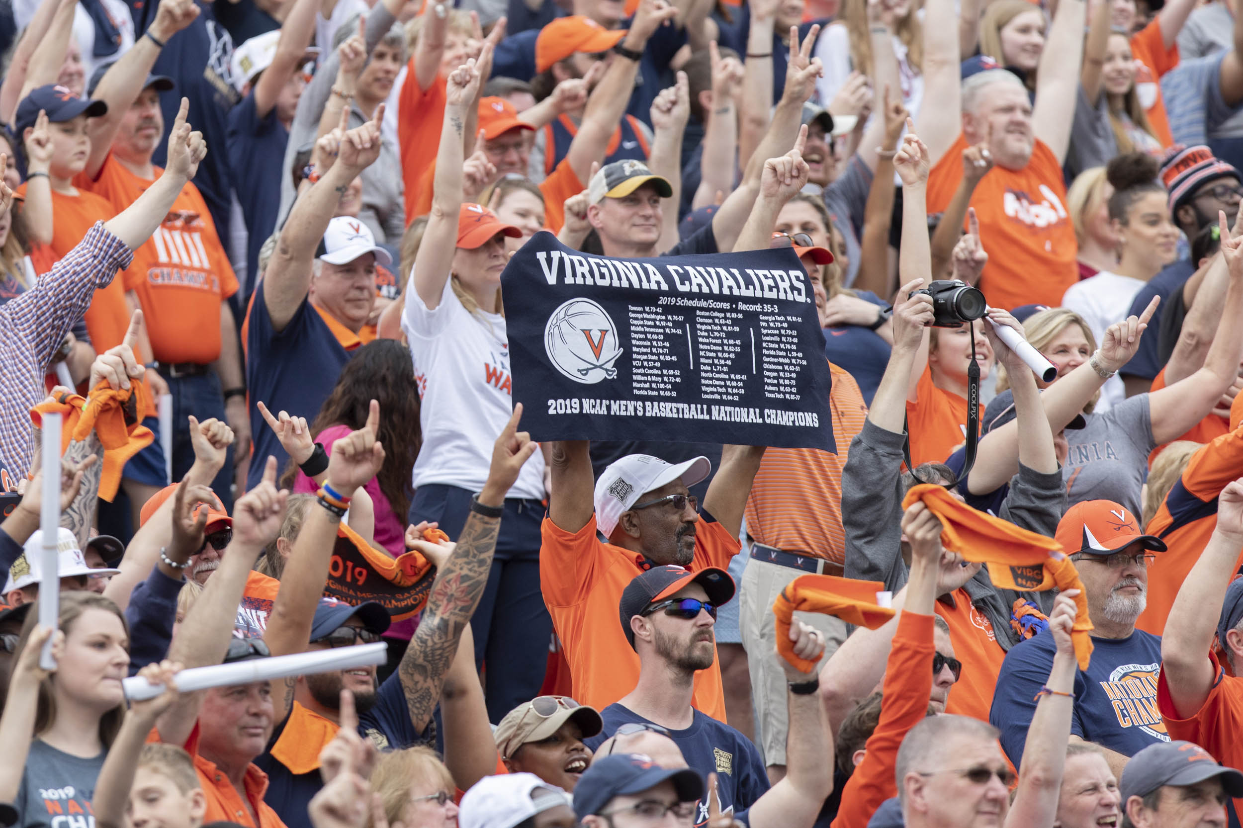 UVA fans cheering and holding signs 