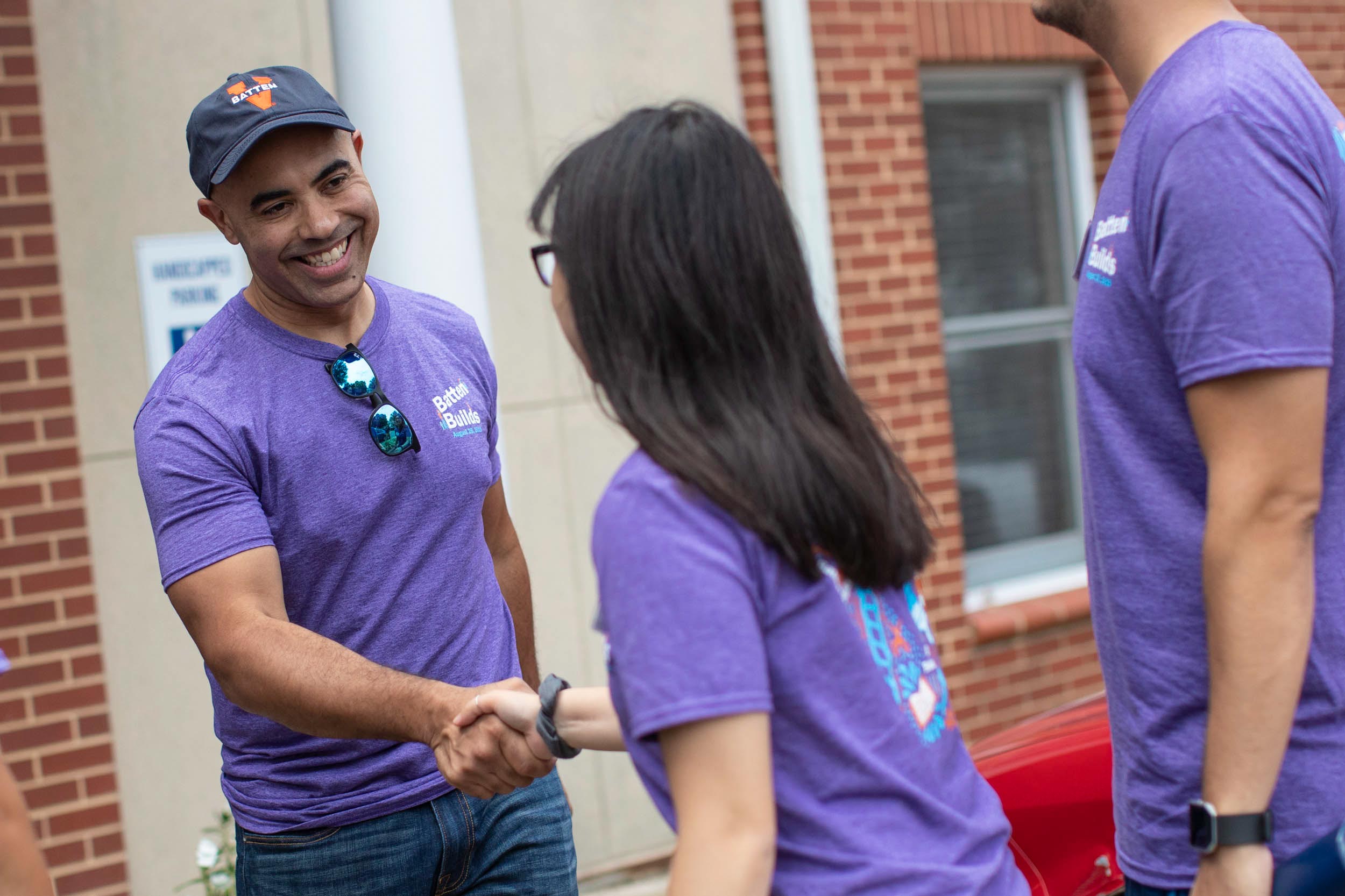 Dean Ian Solomon shakes the hand of a student