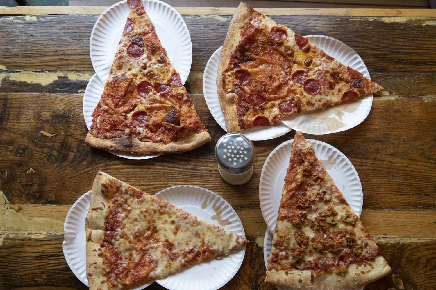 Pizza slices on paper plates