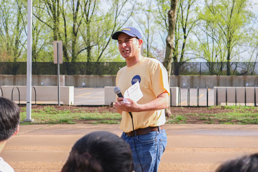 Tim Freilich standing in front of a group of volunteers talking