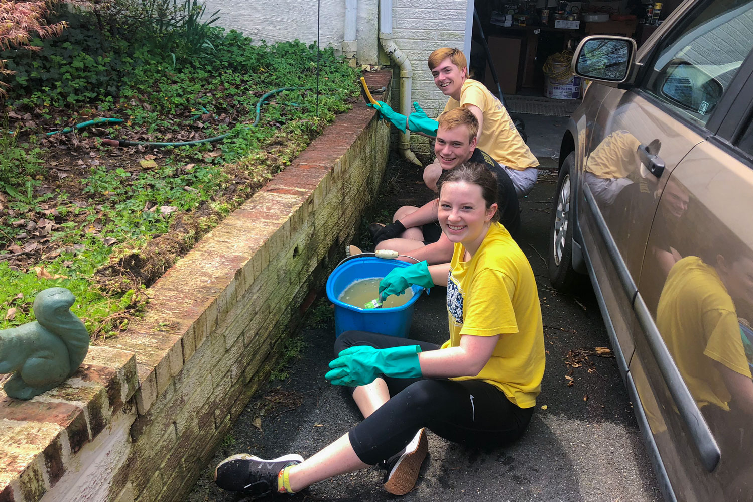 Student volunteers helped clean up outside a private home 