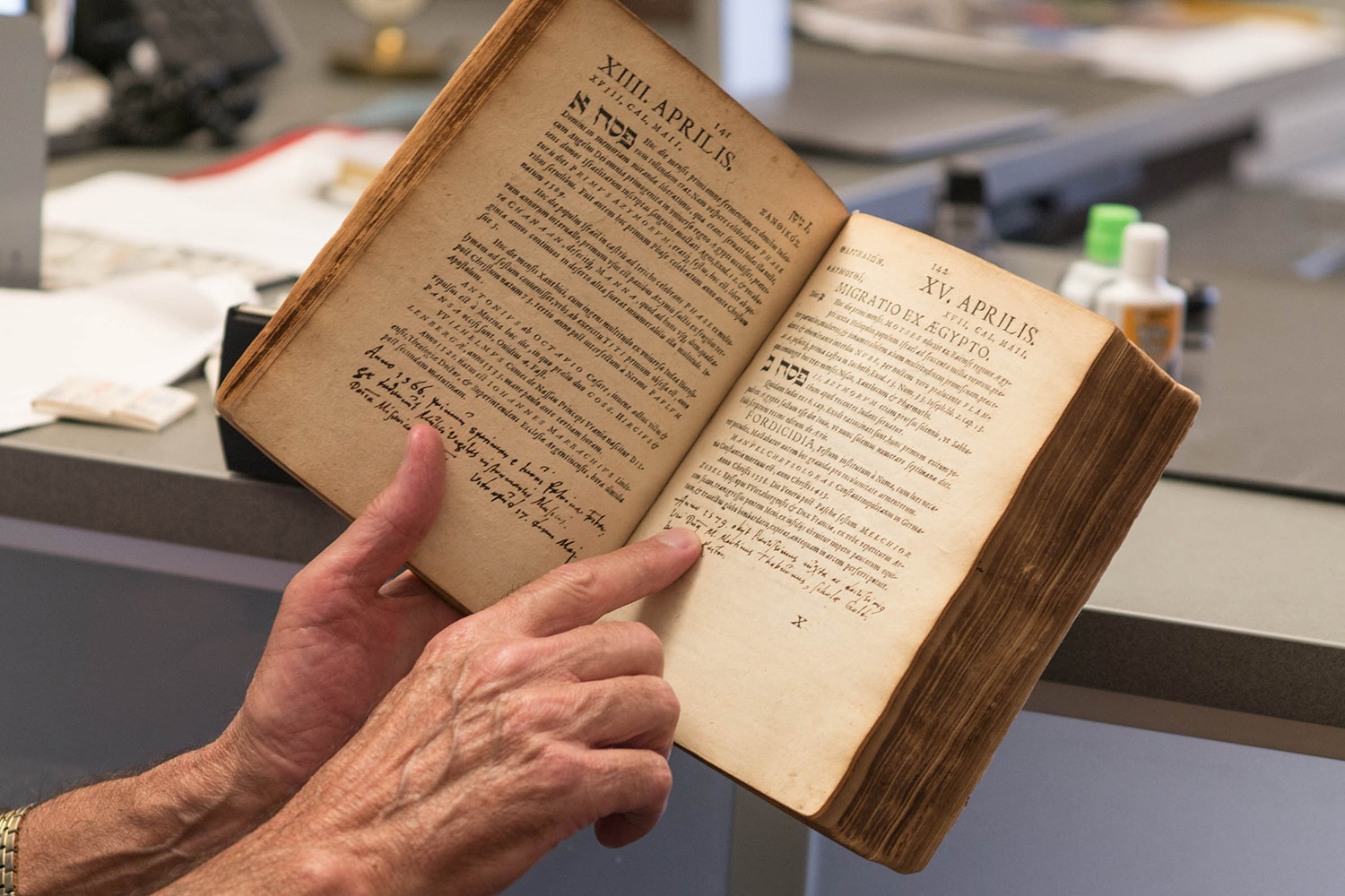 Miller points out Agricola’s personal additions to the printed summary of events inside the daybook. (Photos by Sanjay Suchak)