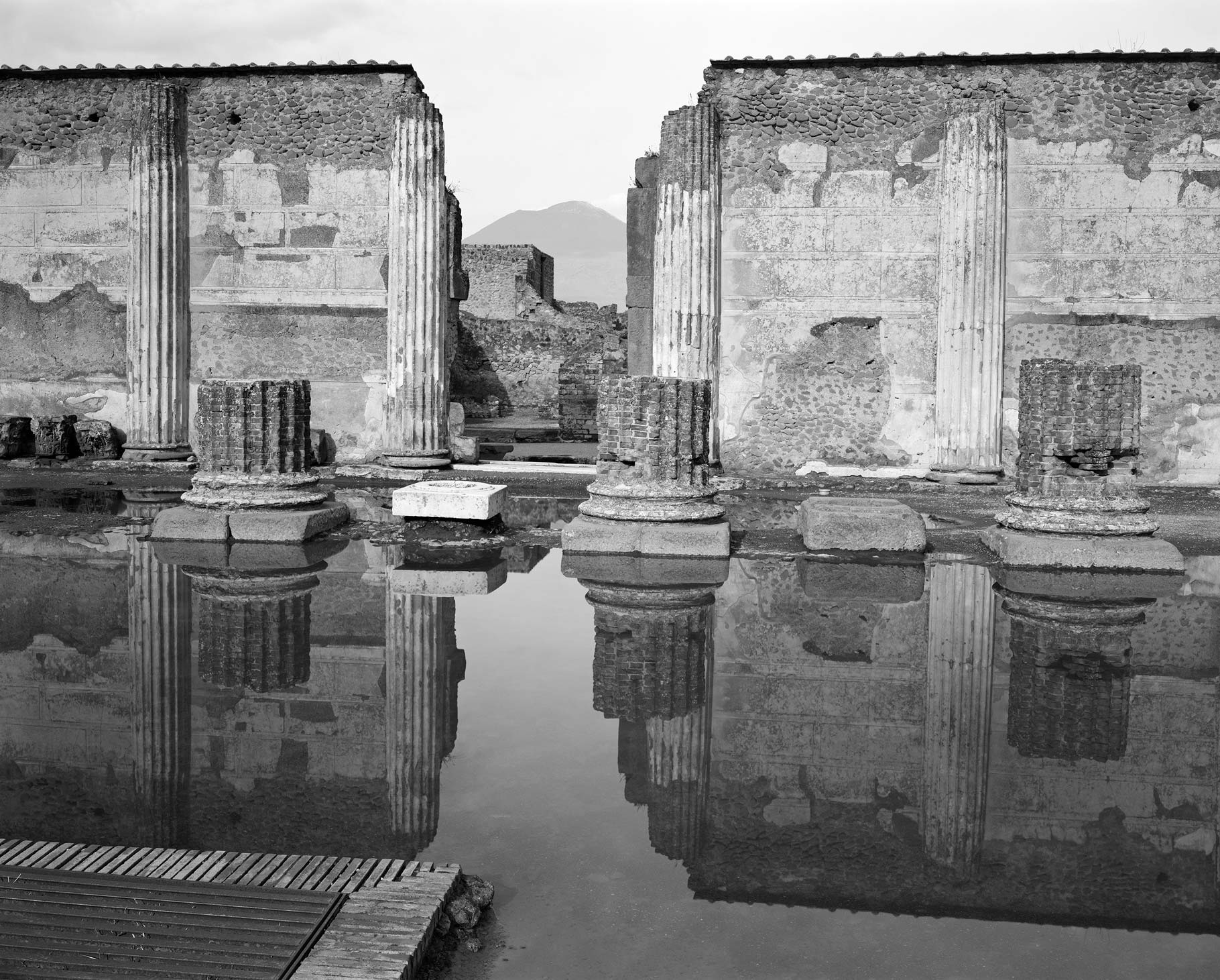 Broken pillars and wall in pompeii, black and white image