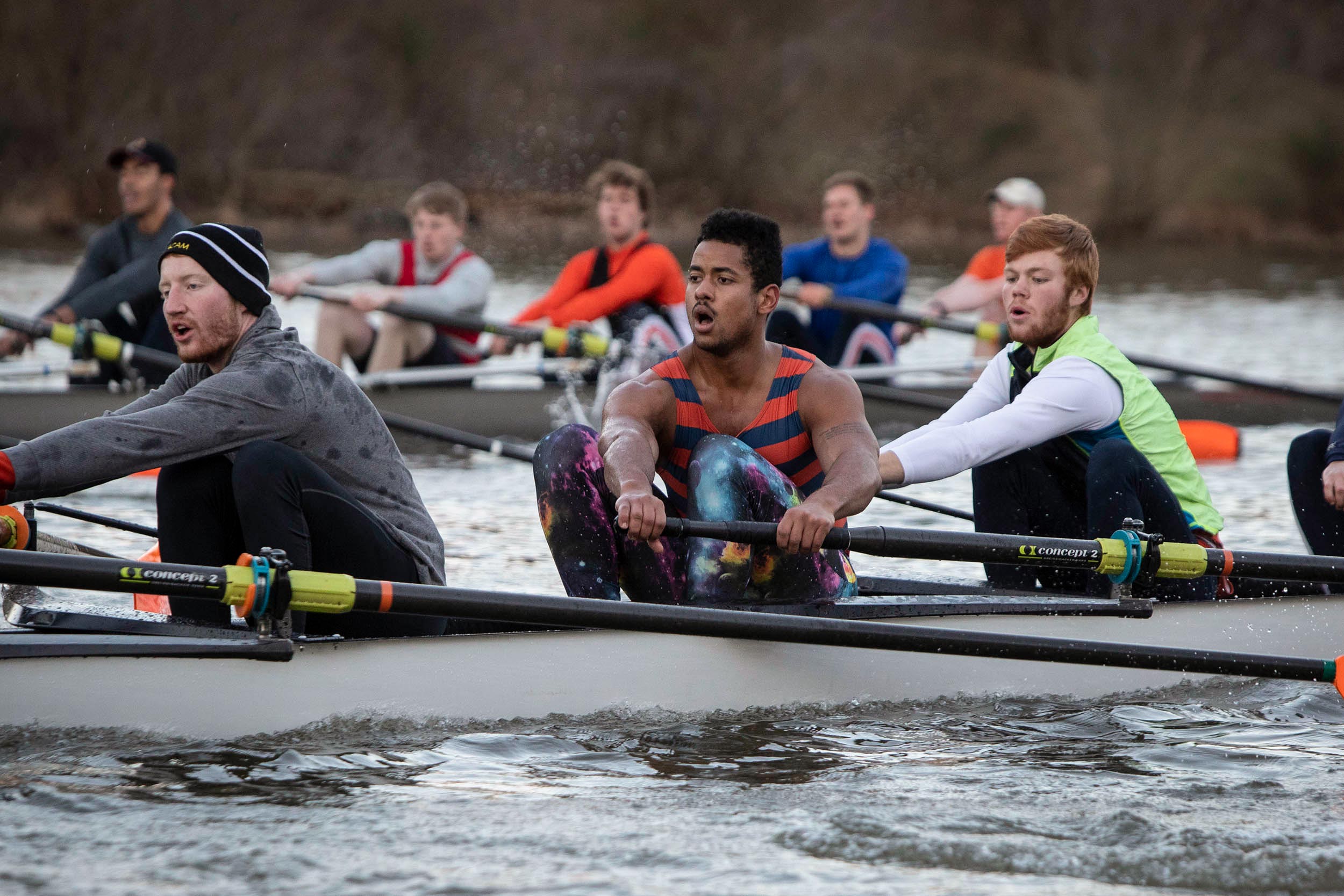 Billy Burris on the mens Rowing team rowing on a river