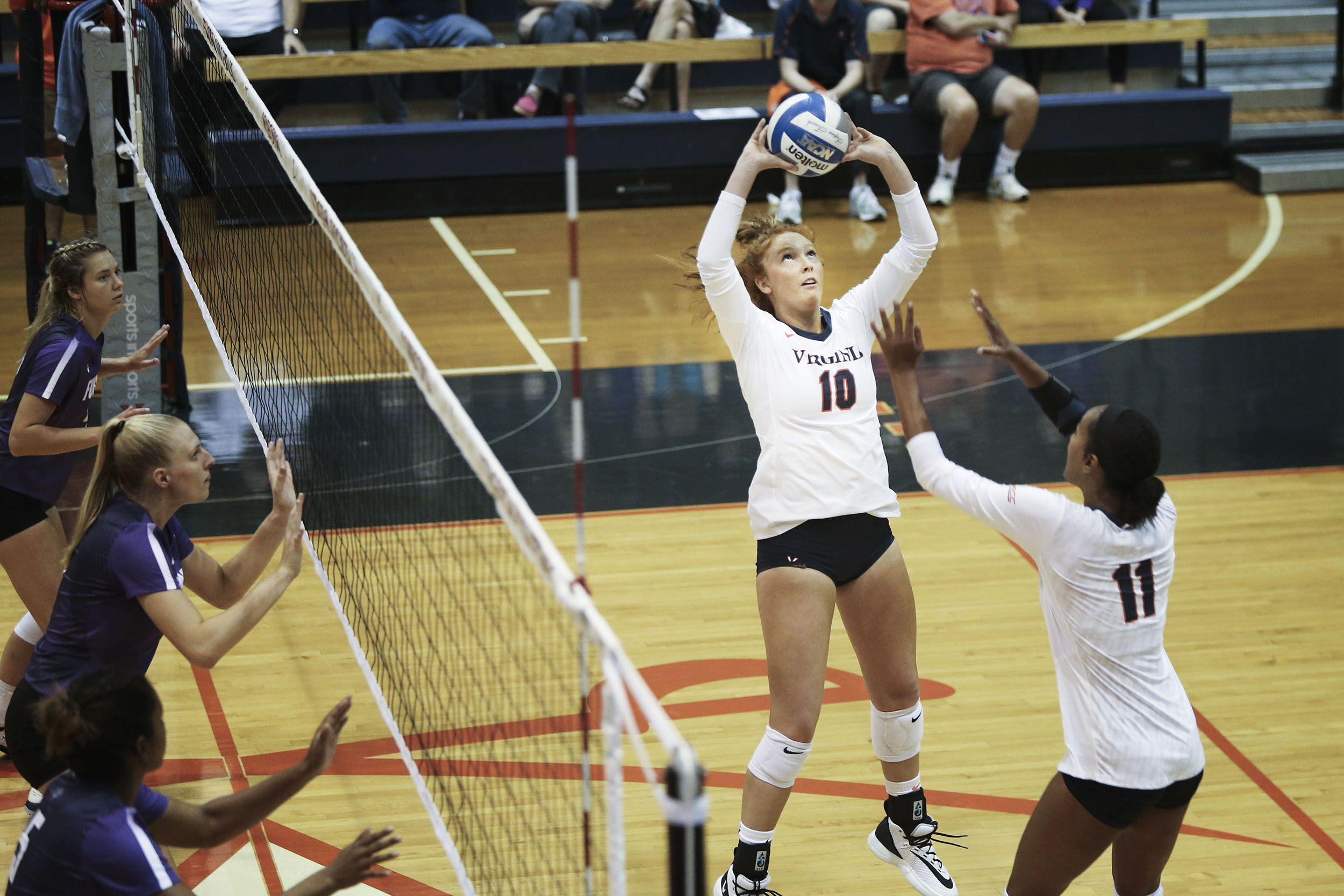 Madeleine Boylston setting a volleyball during a match