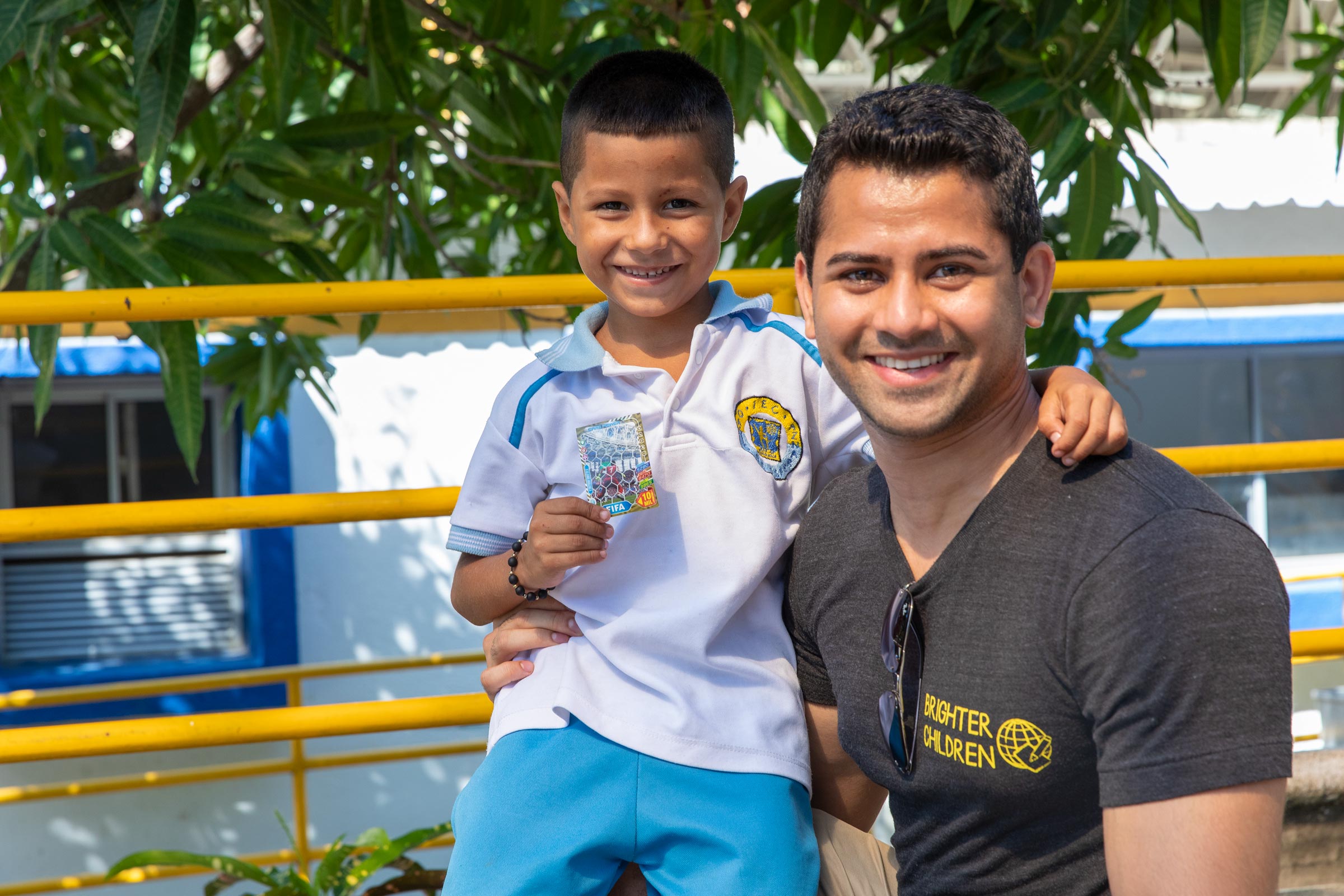 Kunal Doshi  with a student named Darlington pose together for a photo in Colombia