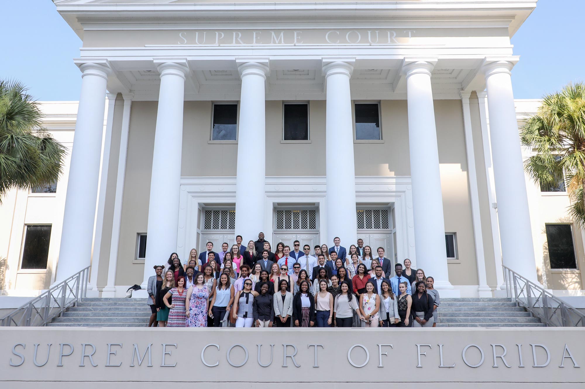 Britney Mangan poses in a group photo in front of the Florida Supreme Court of Florida