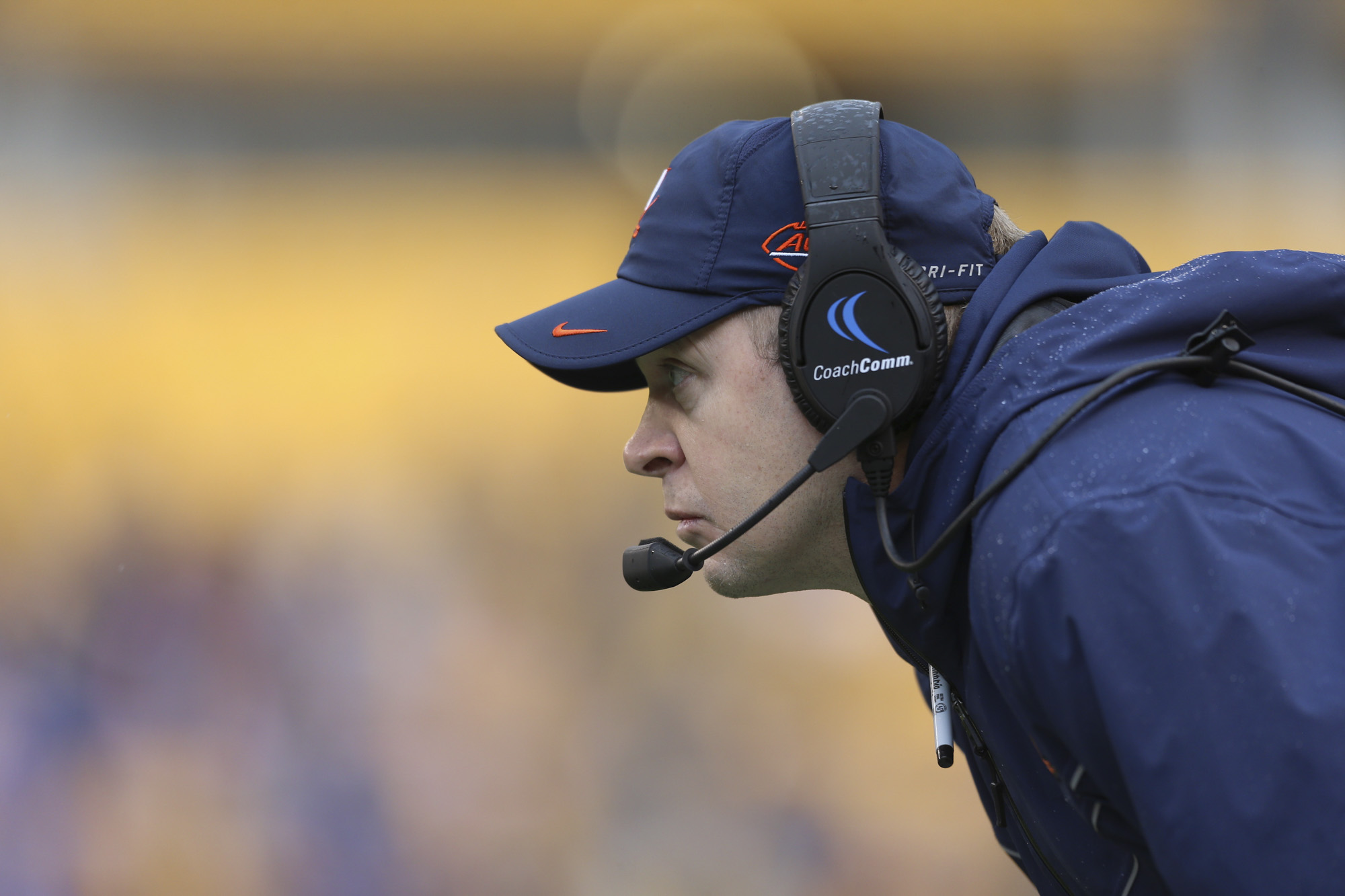 Bronco Mendenhall bent over watching a game intensely  