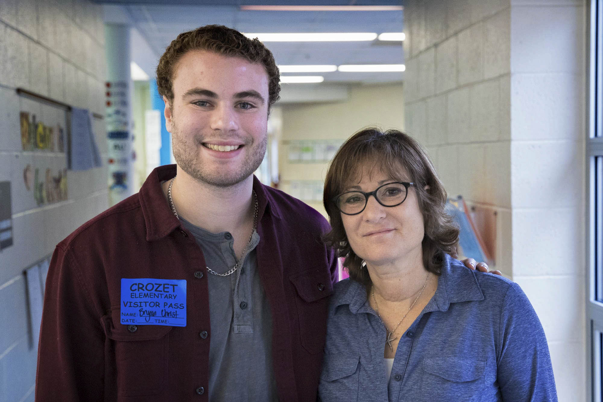 The mother-son team of Bryan and Gina Christ stand next to each other for a picture