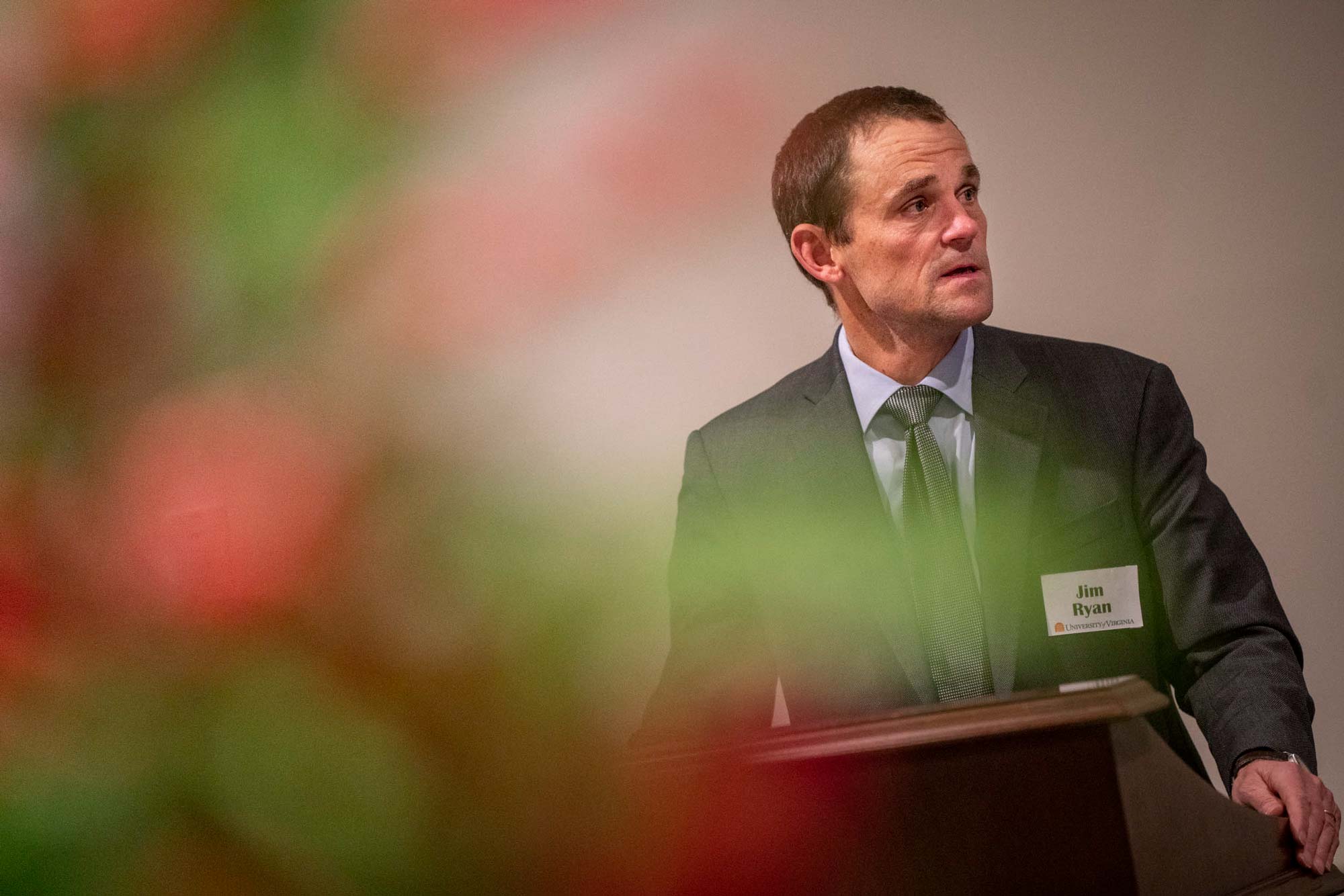 Ryan standing at a podium with green and red blurred colors on the left