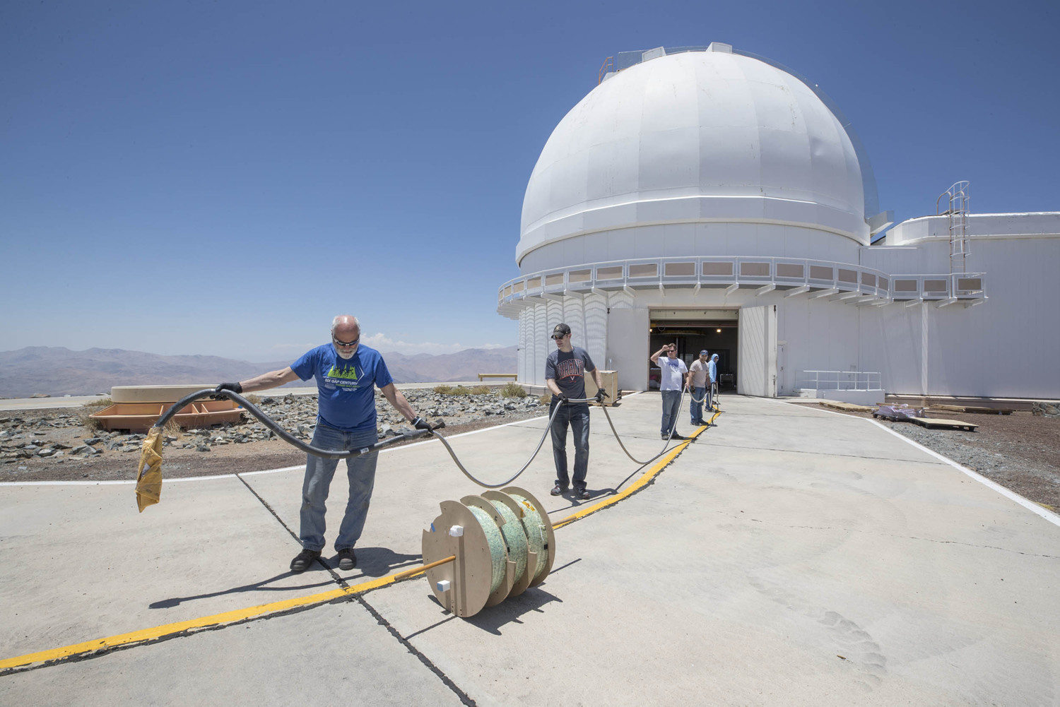 The UVA team spooled out the delicate fiber-optic cable that runs from the instrument to the telescope. 