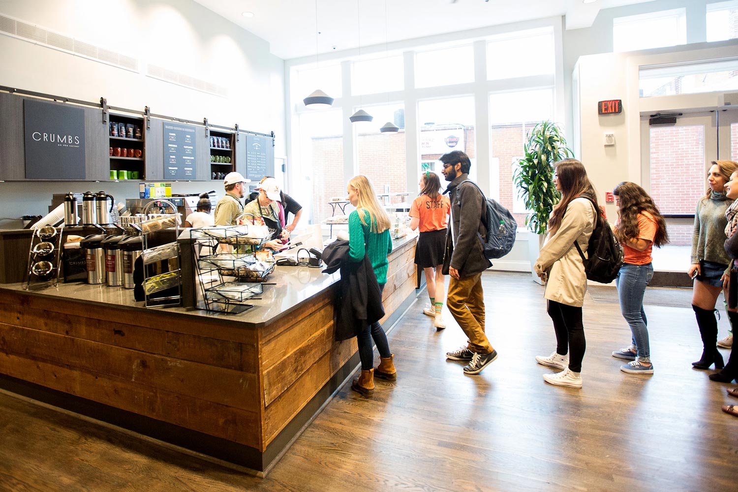 people standing in line getting coffee