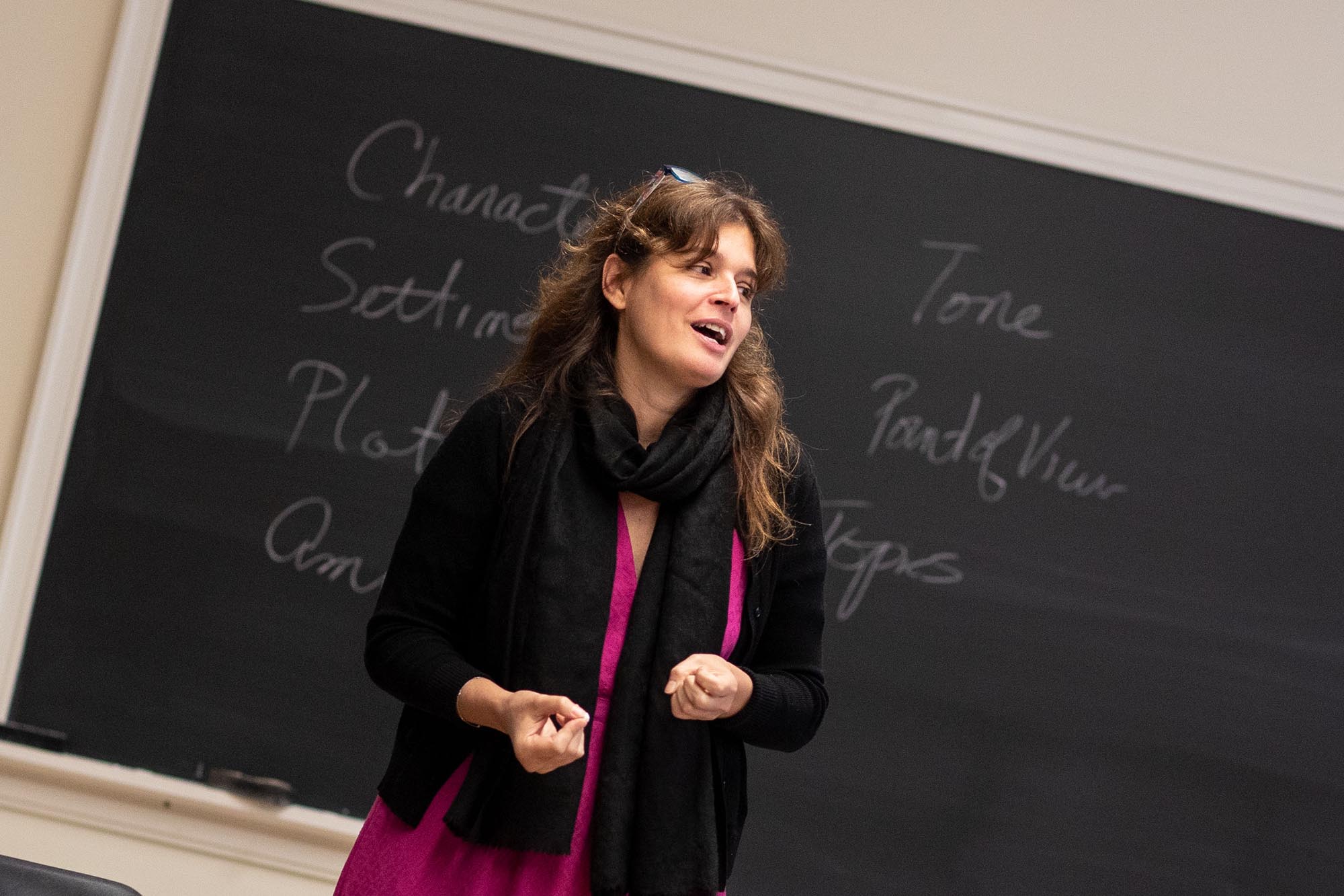 Carmen Lamas standing in front of a chalkboard talking to a class