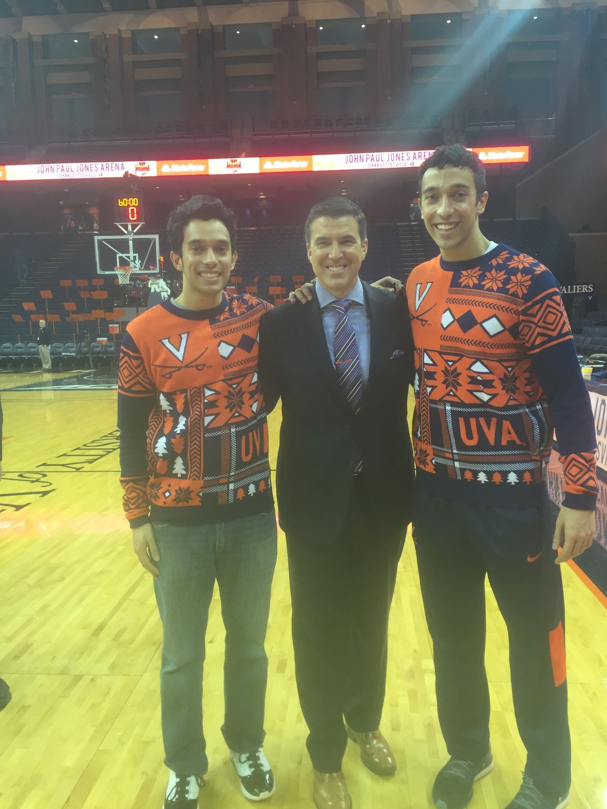Mikey Carpenter, Rece Davis, and Johnny Carpenter stand on the basketball court for a picture