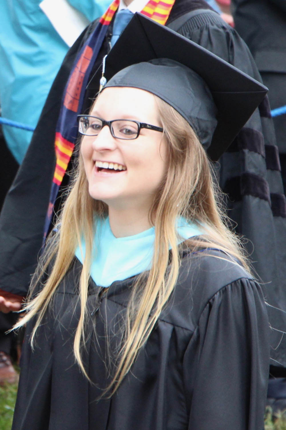 Casedy Thomas smiles while she is in her graduation cap and grown