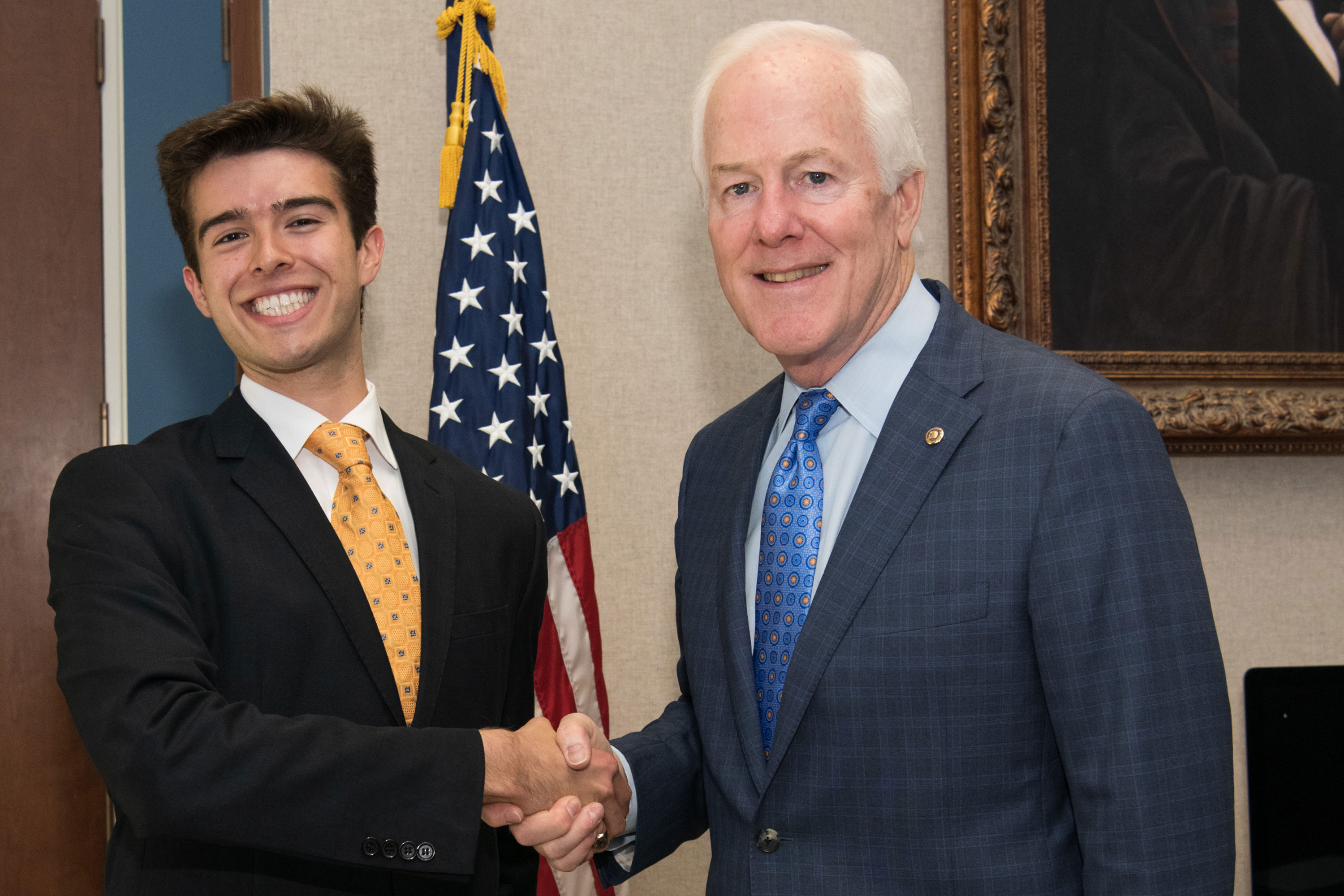 Max Castroparedes, left, and U.S. Sen. John Cornyn, right pose for a picture together