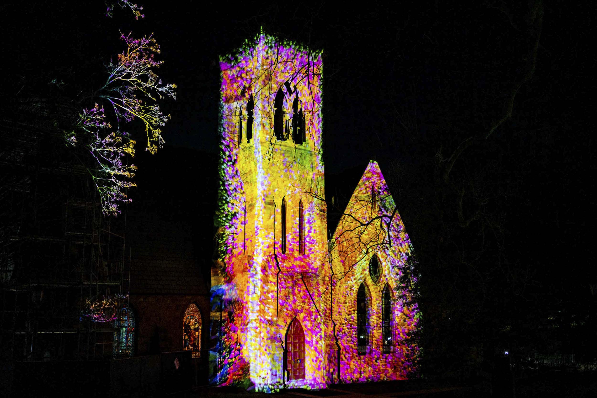 UVA Chapel Bell tower having multiple colors projected onto it.