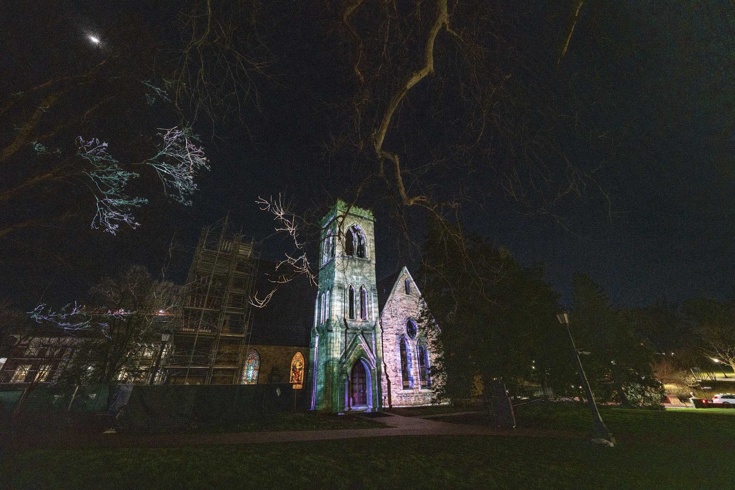 UVA chapel lit up by white lights at night