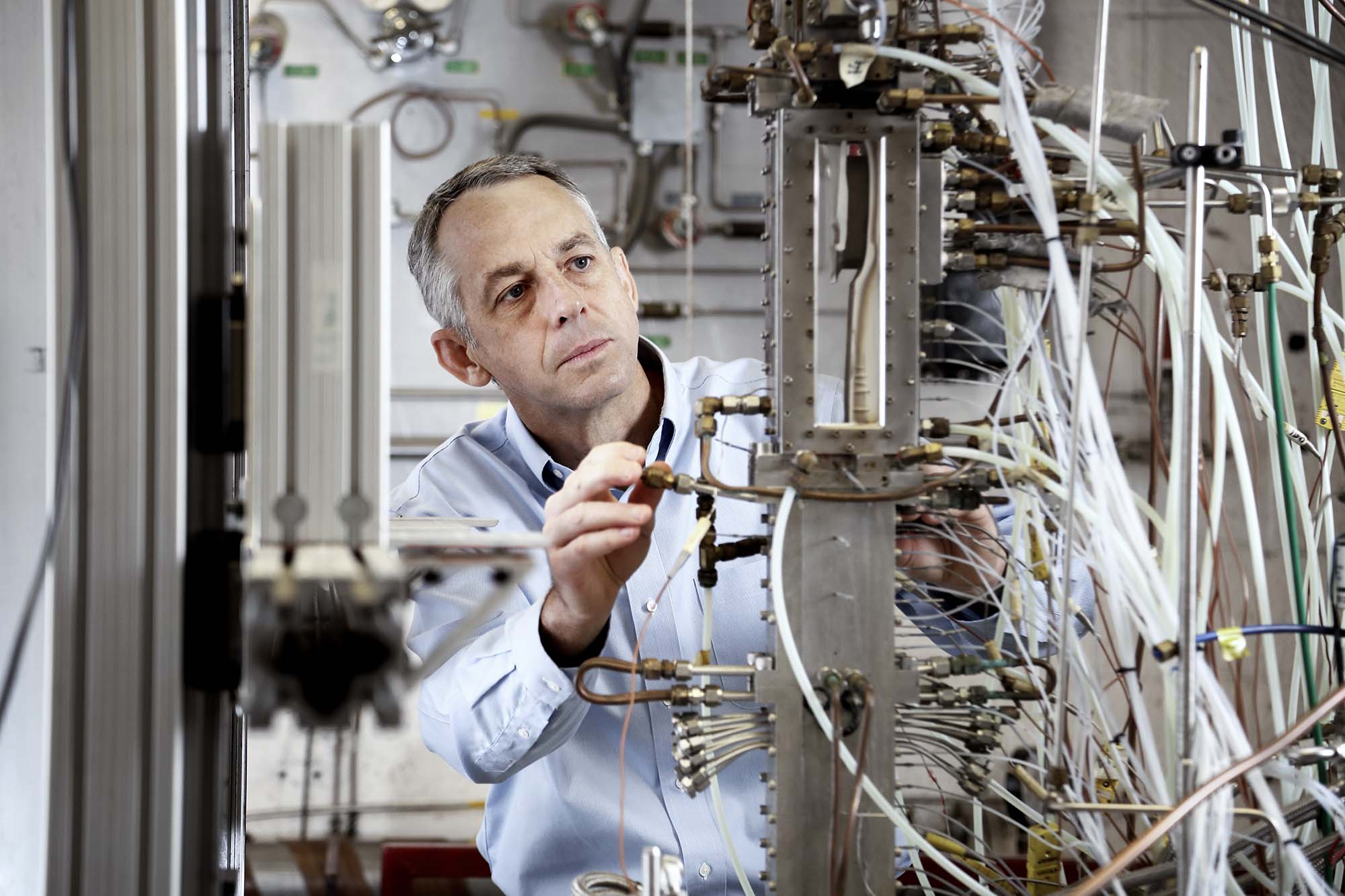 Christopher Goyne working on a machine in the lab