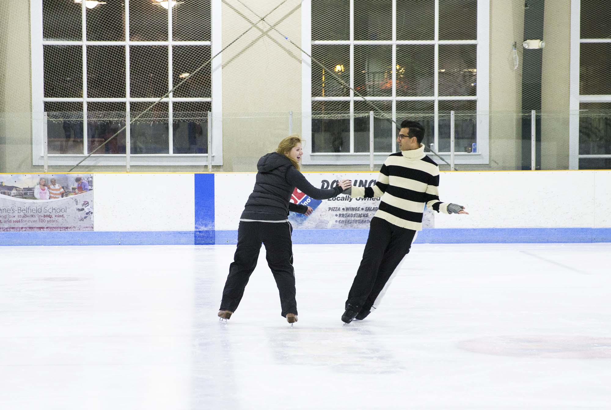 Christopher ali and woman skating hand in hand