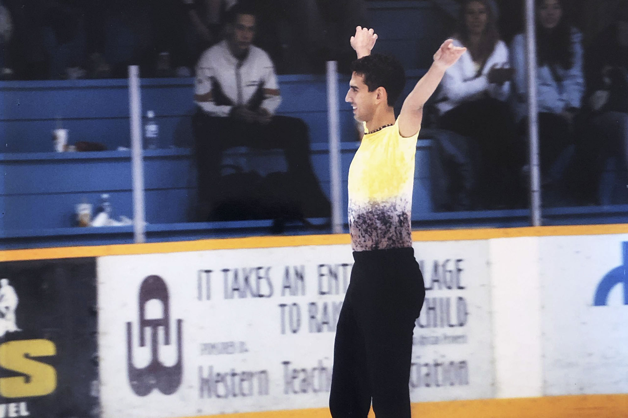 Christopher Ali on the ice with arms raised