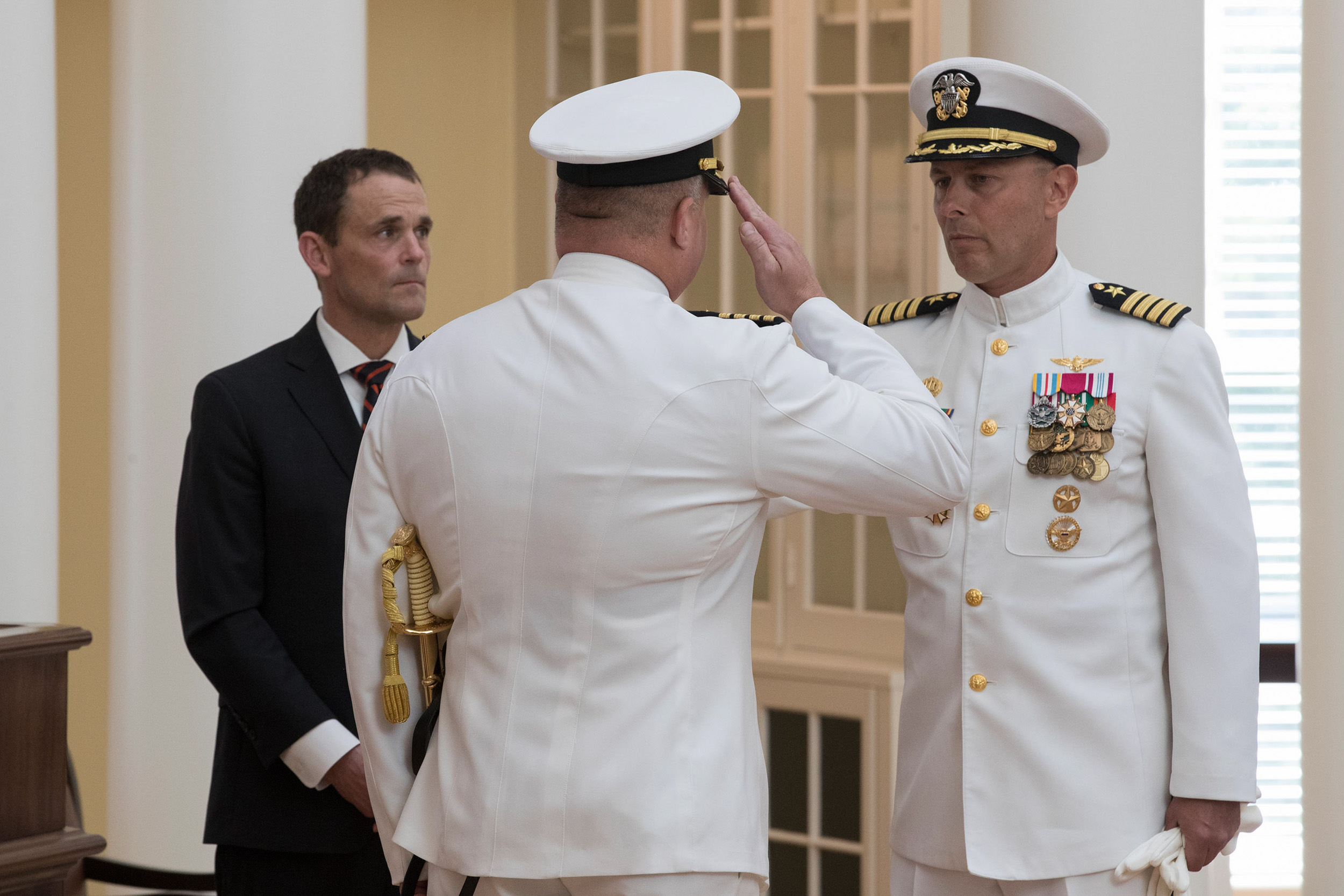 UVA President Jim Ryan, left, presides over the retirement ceremony in which U.S. Navy Capt. Christopher Misner, right, turned command over to Capt. Kevin Kennedy.