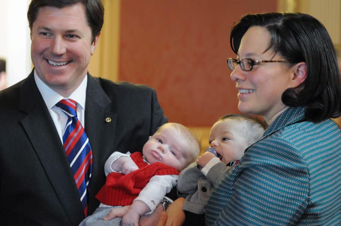 Two politicians holding babies.