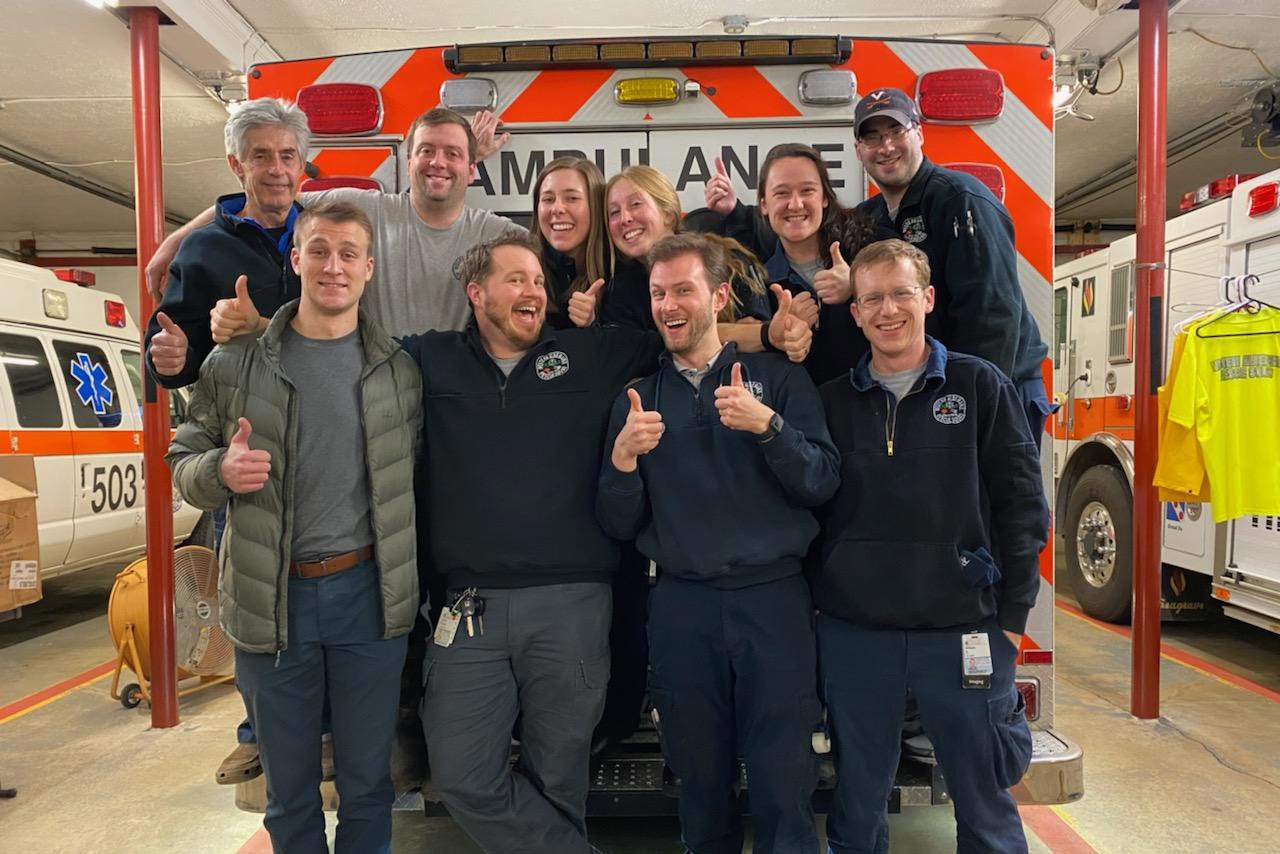 Janek and her Western Albemarle Rescue Squad teammates pose at the back of an ambulance for a group photo