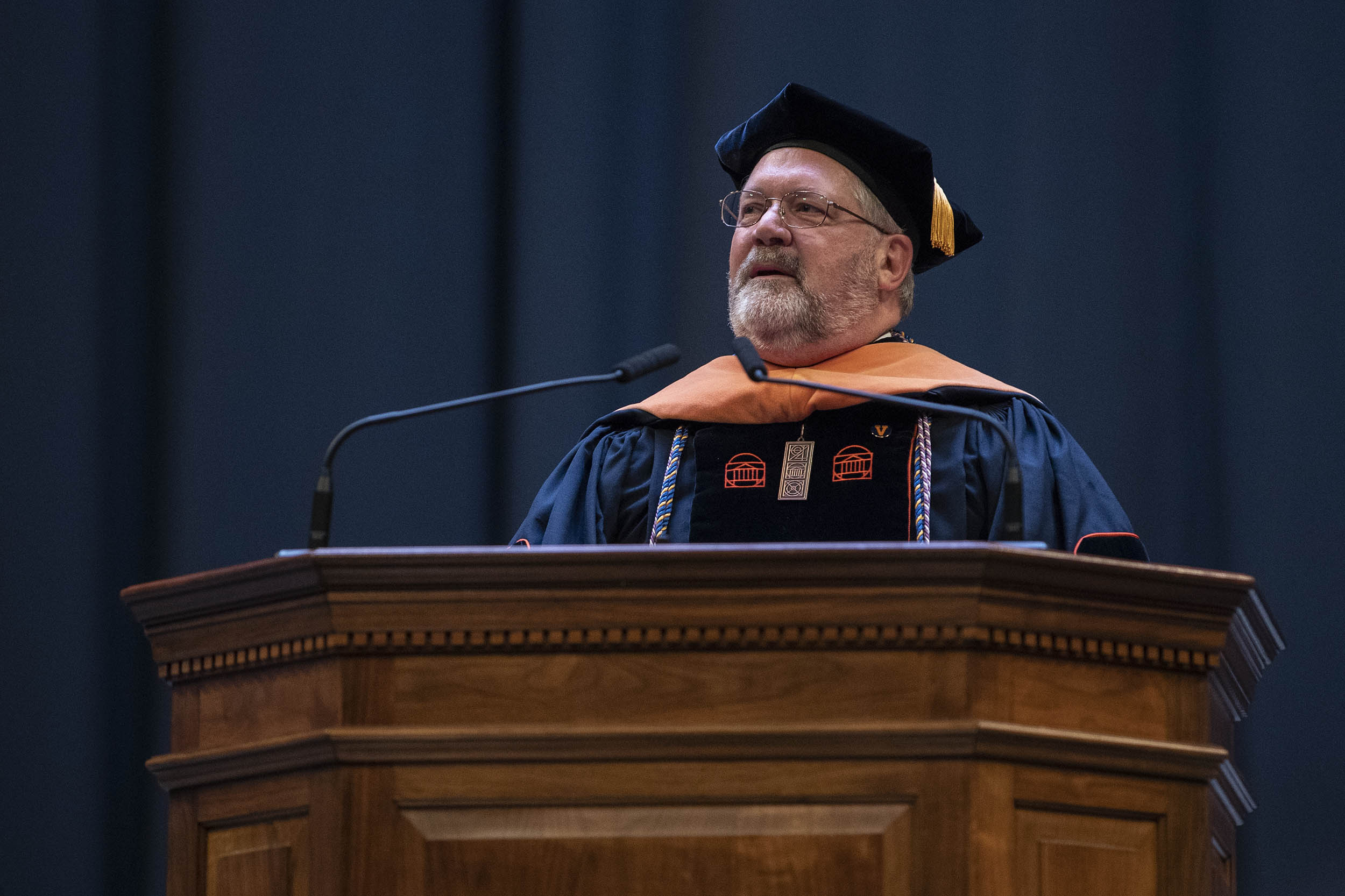 Richard M. Carpenter stands at a podium giving a speech